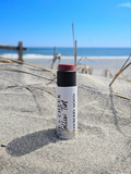 Small-batch natural tallow lip tint tube with castor oil, beeswax, mica, and iron oxide for a smooth high-shine lip flush.