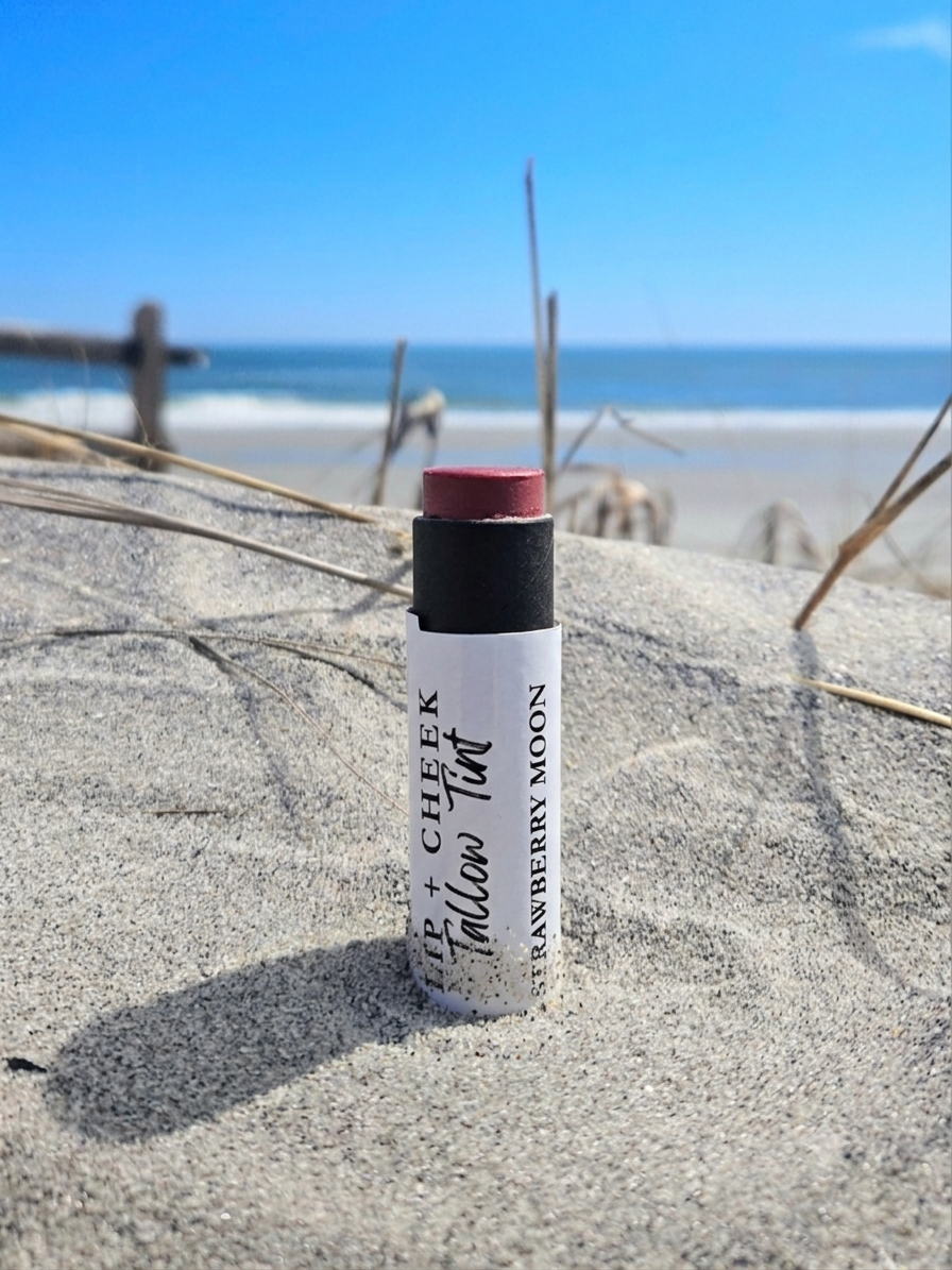 Small-batch natural tallow lip tint tube with castor oil, beeswax, mica, and iron oxide for a smooth high-shine lip flush.